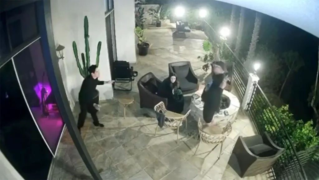 Tom Sandoval shoves Victoria Robinson's dad toward a firepit while a woman watches.