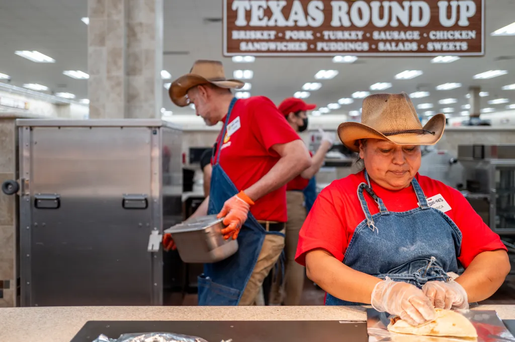 Employees prepare food inside the Buc-ee's convenience store.