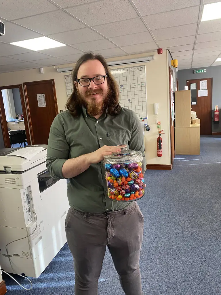 Josh Kerry, a murder suspect, holding a jar of colorful Easter eggs.