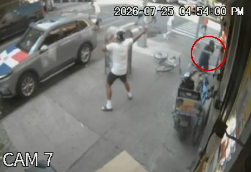 CCTV footage captures a person with their arm extended, appearing to hold a firearm, with another person circled in red in the background, near a car with a Dominican Republic flag design on its hood.