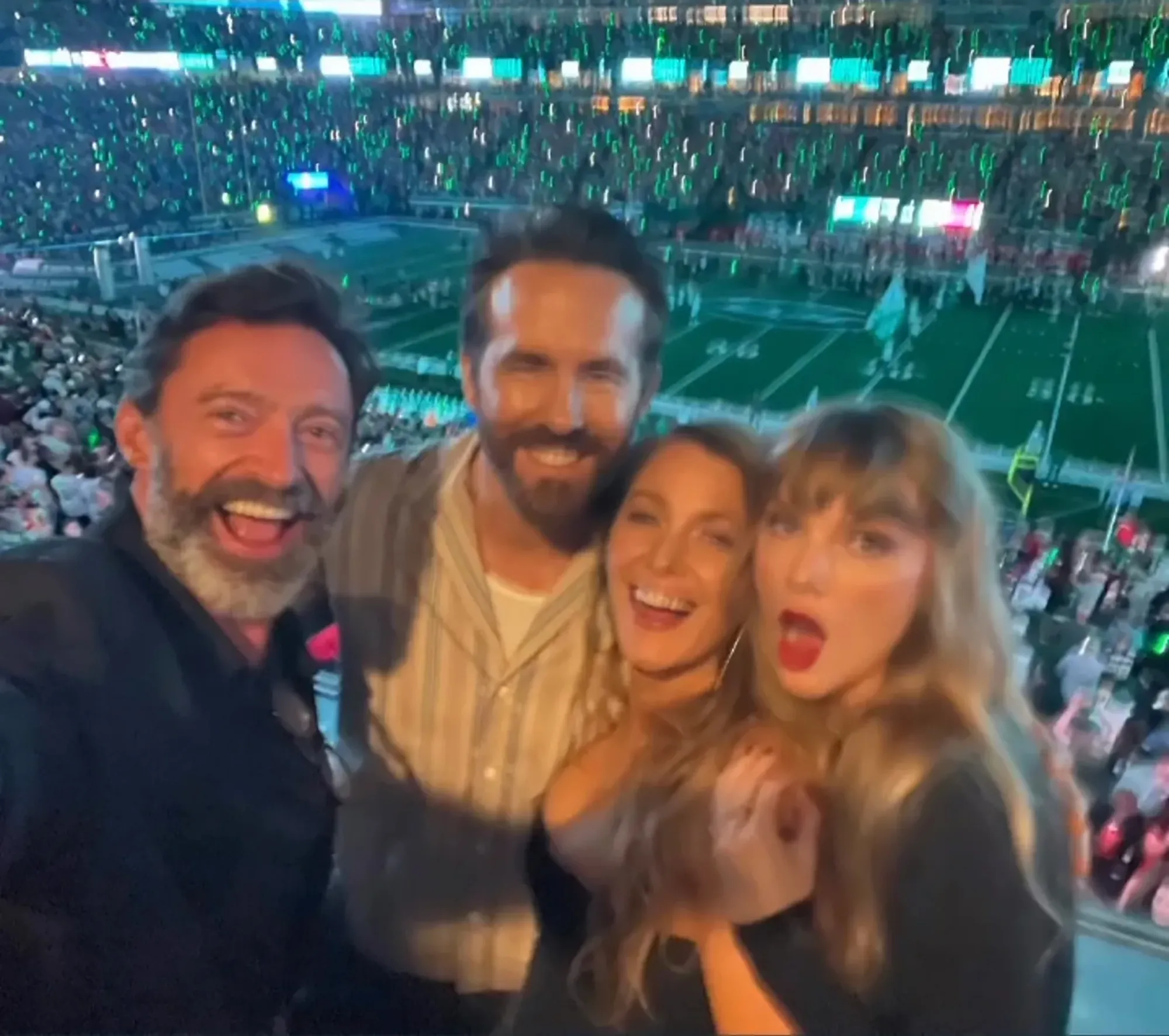 Hugh Jackman, Ryan Reynolds, Blake Lively, and Taylor Swift pose for a selfie at a Chiefs game.