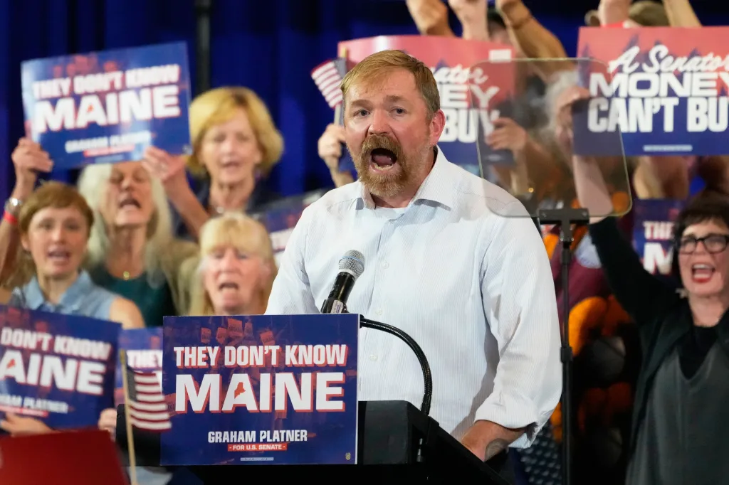 U.S. Senate candidate Graham Platner speaks to supporters at a podium with a