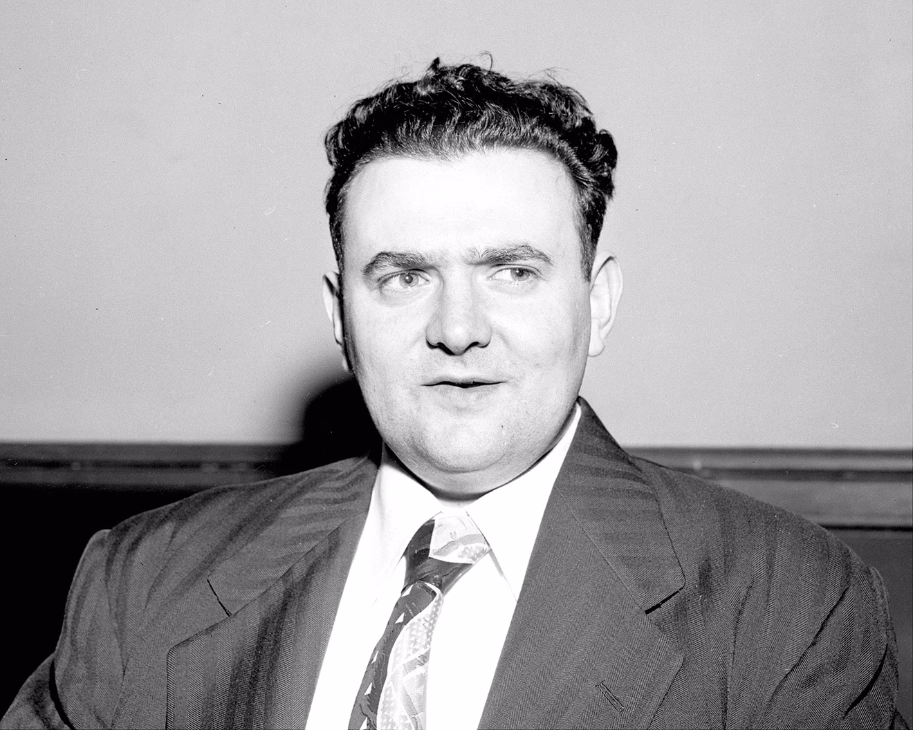 black-and-white archival photo of man in suit and tie