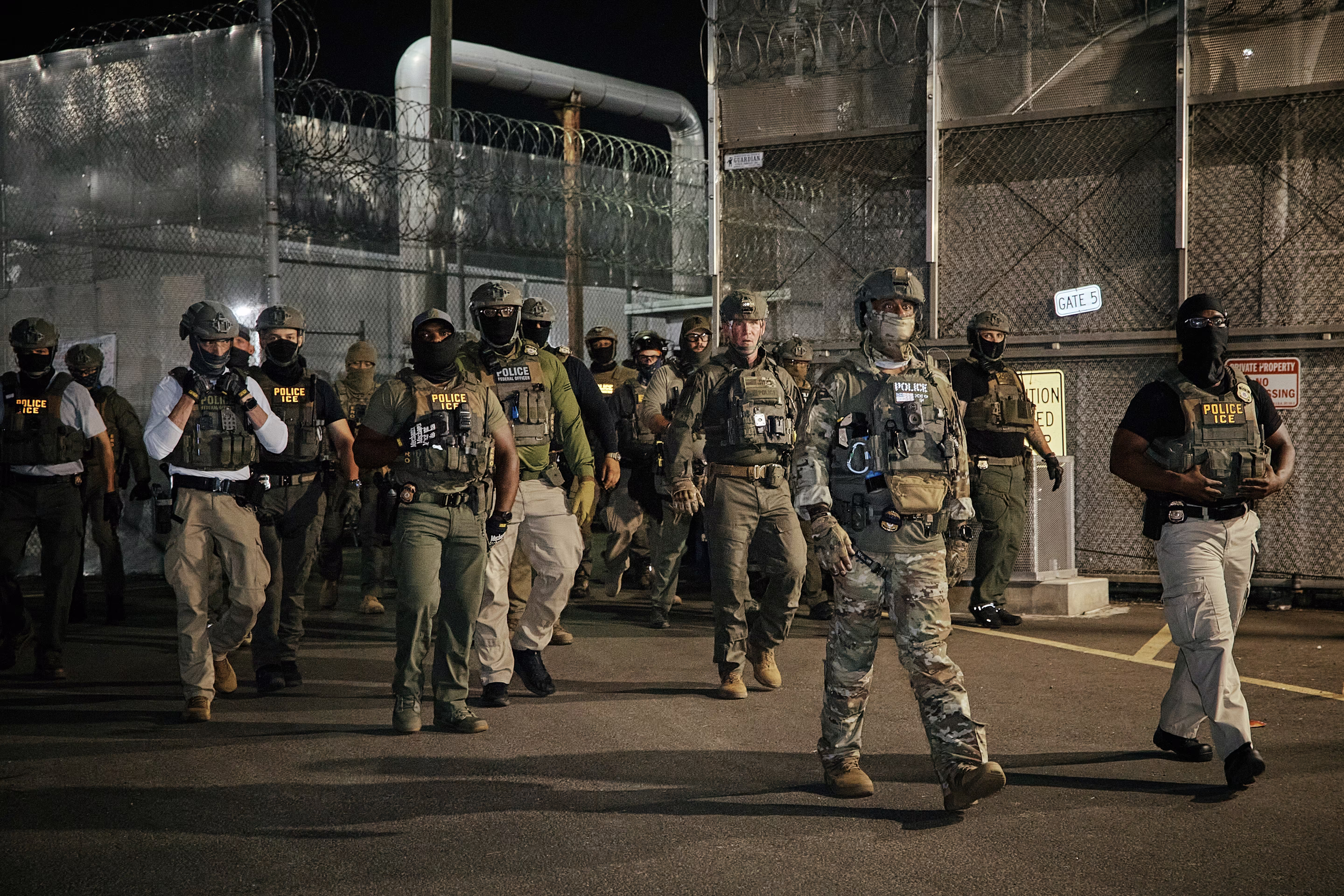 armed police men walk forward as a group
