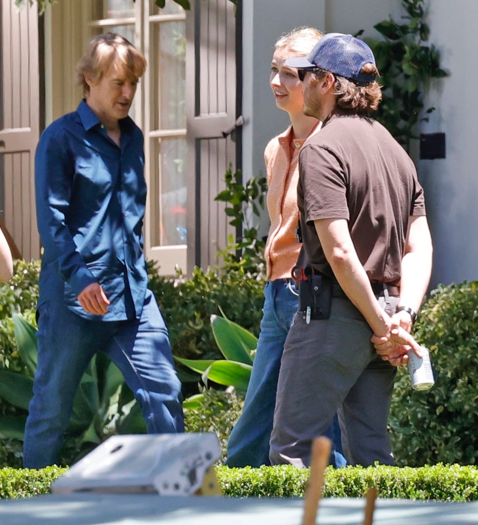 Owen Wilson, Apple Martin, and a crew member on the set of "Paris Paramount."