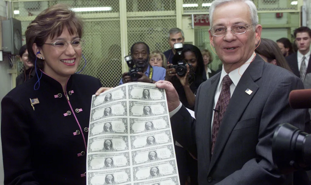 Treasury Secretary Paul O'Neill and U.S. Treasurer Rosario Marin hold a sheet of Series 2001 One Dollar bills.