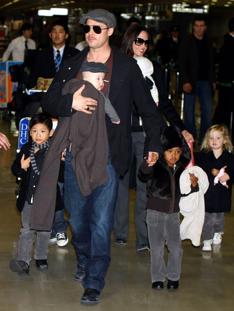 Brad Pitt, Angelina Jolie, and their four children arrive at Narita International Airport.