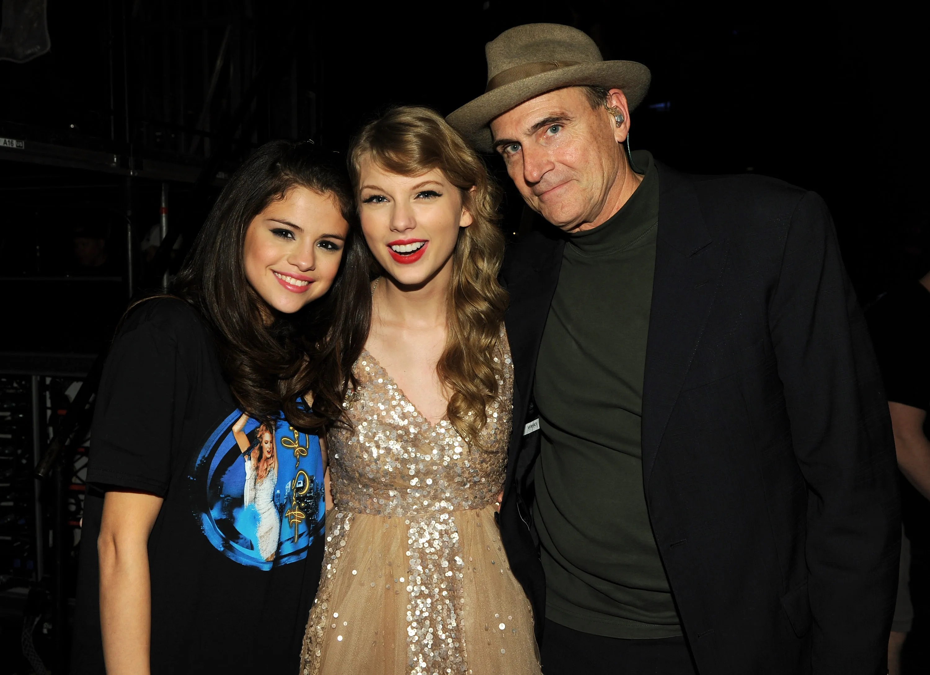 Selena Gomez, Taylor Swift, and James Taylor posing backstage during the "Speak Now World Tour" in New York City.