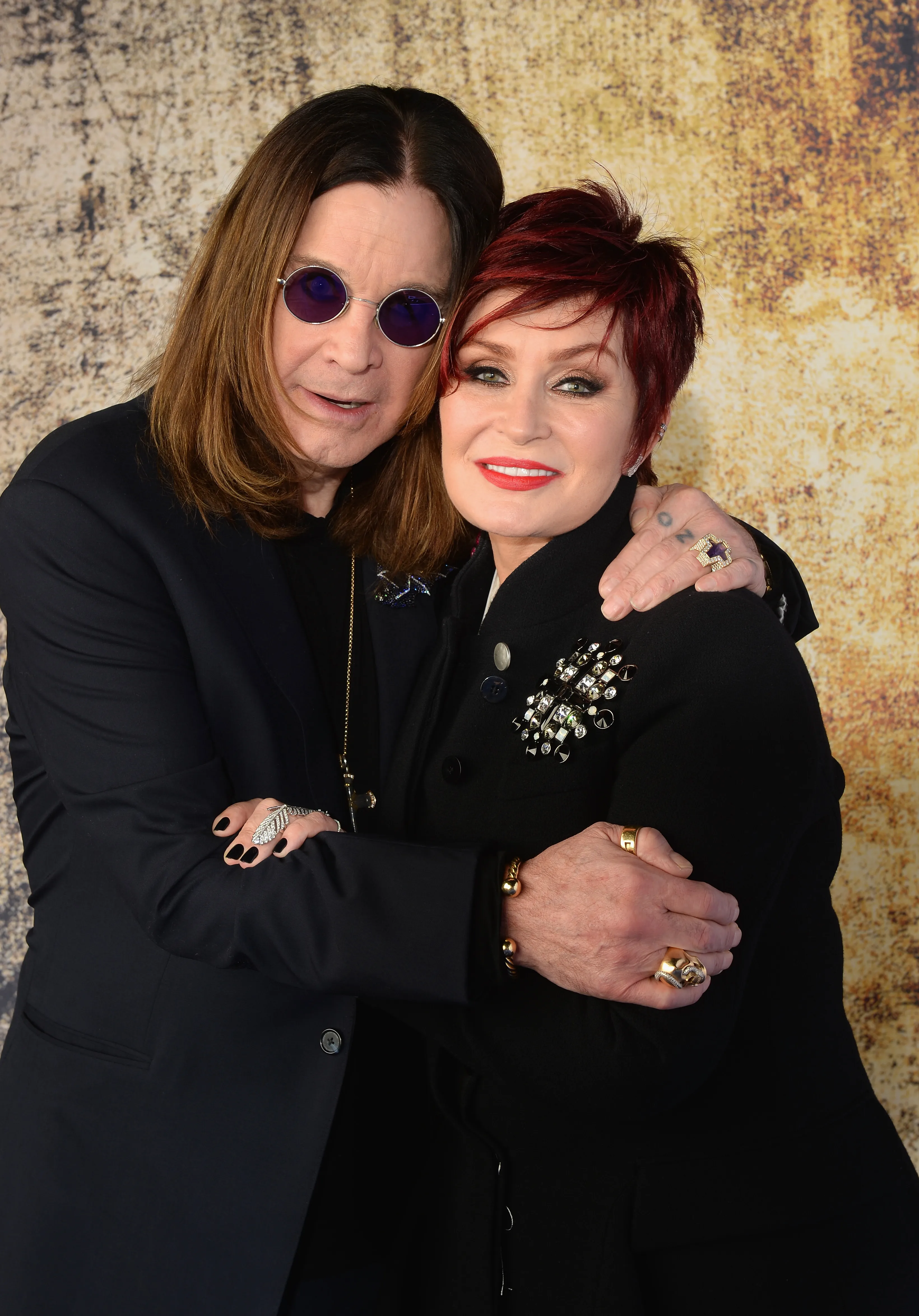 Ozzy Osbourne and Sharon Osbourne embracing.