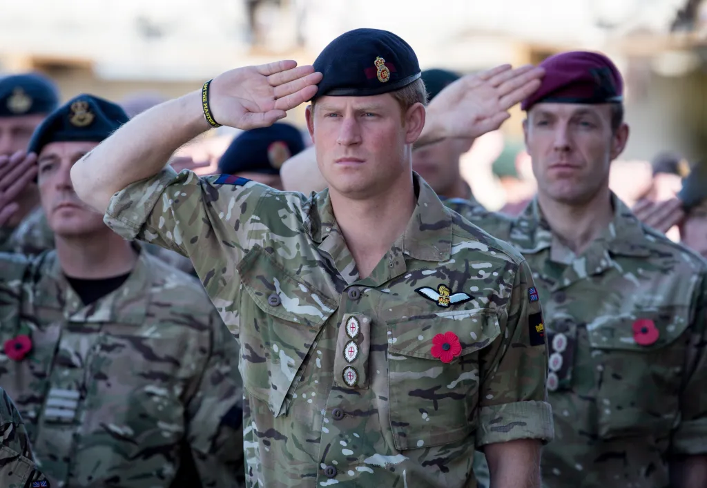 Prince Harry salutes during a Remembrance Sunday service at Kandahar Airfield.