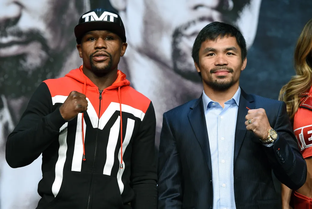 Boxers Floyd Mayweather Jr. and Manny Pacquiao pose for a photo.