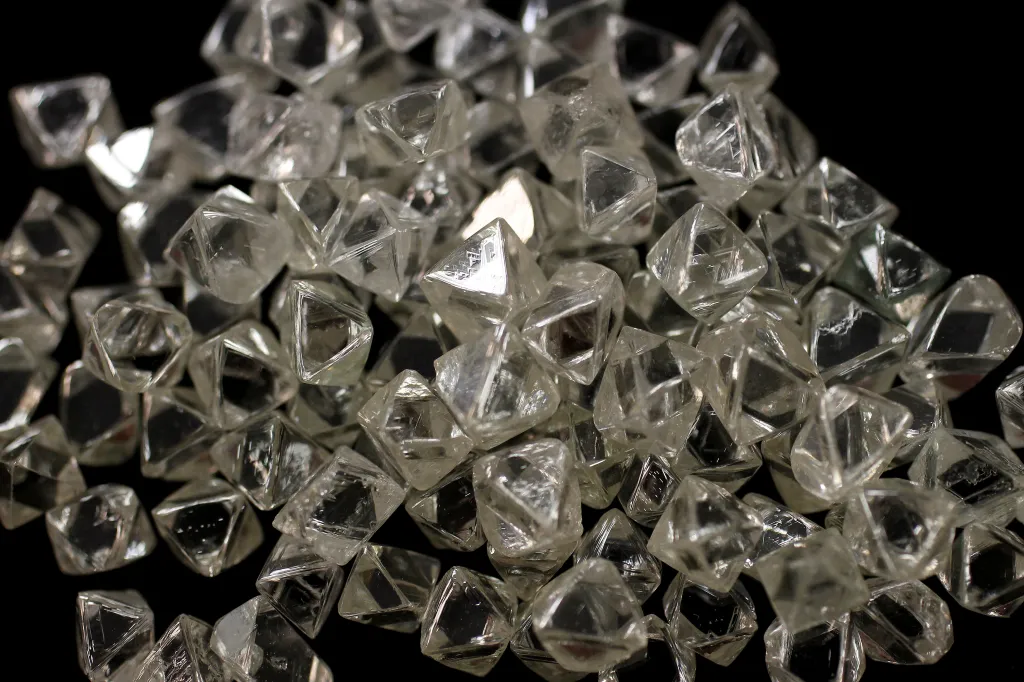 Raw diamonds against a black background.