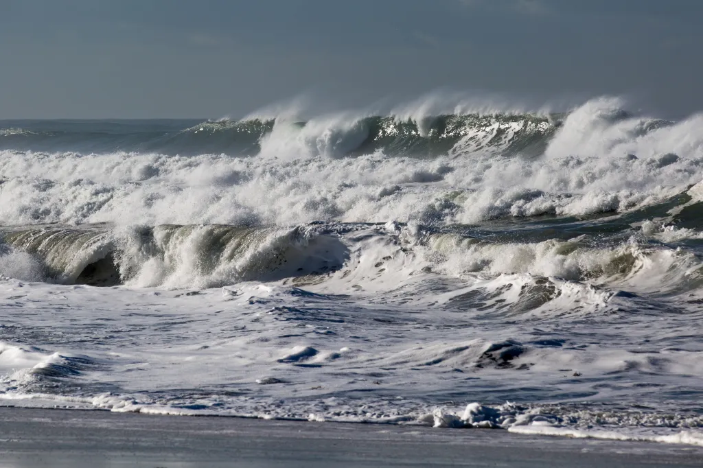 Massive waves crash on the coast of San Diego, California.