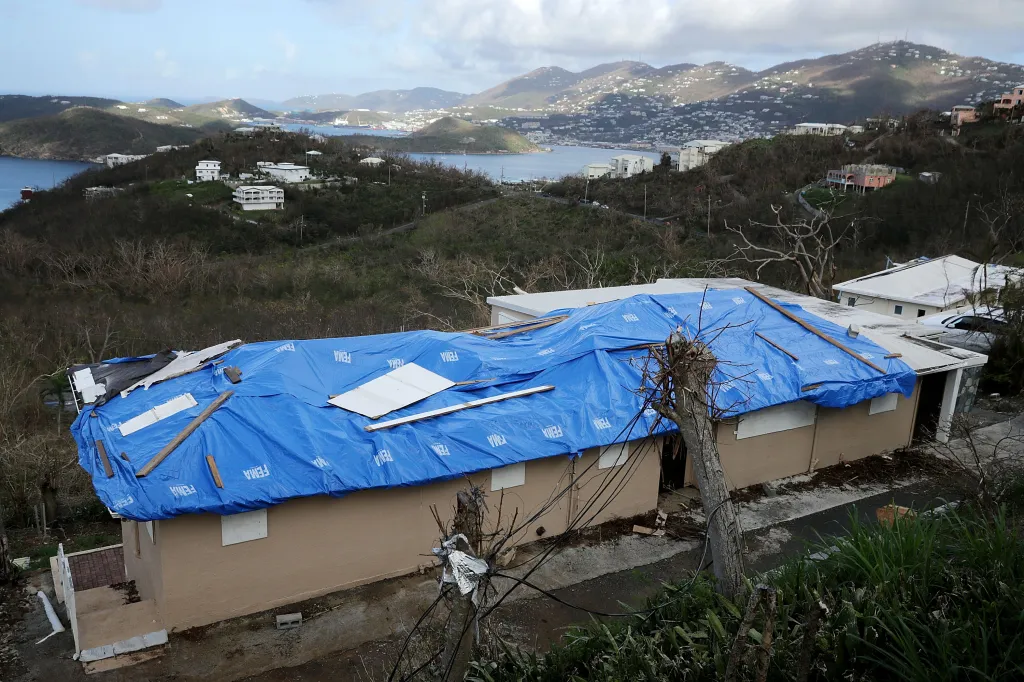 A blue tarp with the FEMA logo covers the roof of a house in the hills above Charlotte Amalie, St. Thomas, U.S. Virgin Islands, following Hurricane Irma.