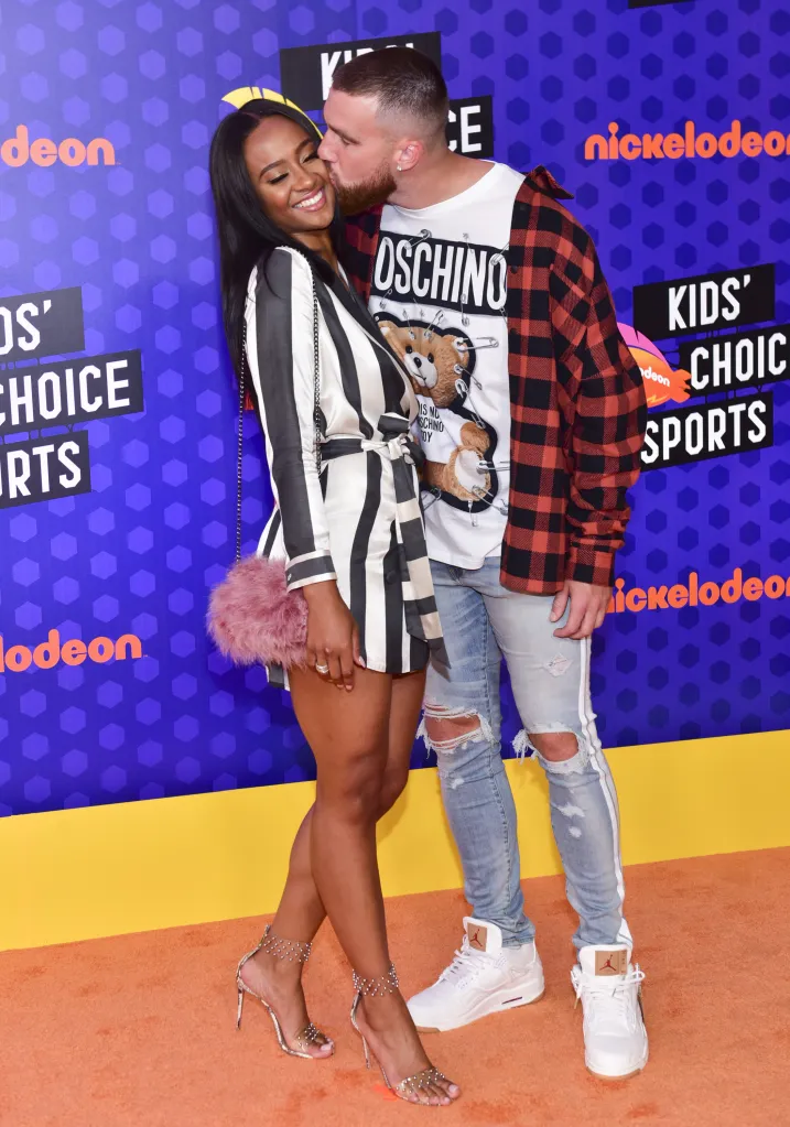 NFL player Travis Kelce kissing Kayla Nicole on the cheek at the Nickelodeon Kids' Choice Sports Awards.