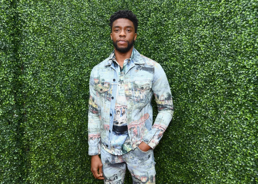 Chadwick Boseman in a patterned denim jacket and pants.