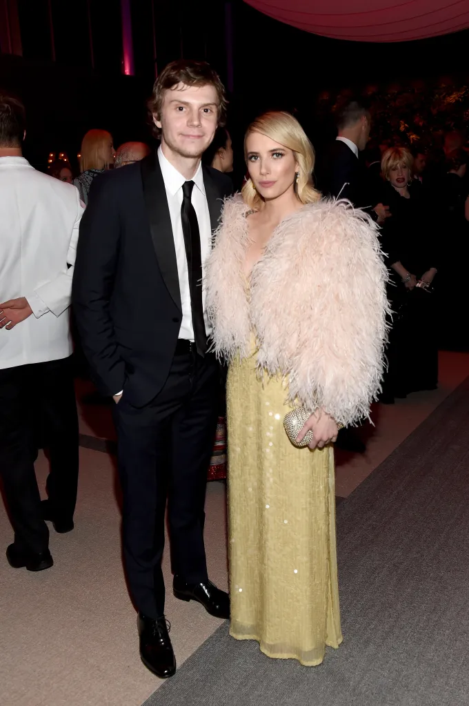 Evan Peters and Emma Roberts pose for a photo at the 2018 Vanity Fair Oscar Party.
