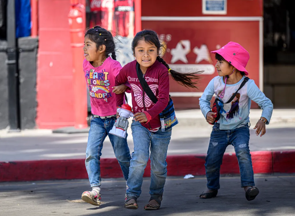 Three children playing in Tijuana while waiting to enter the U.S.