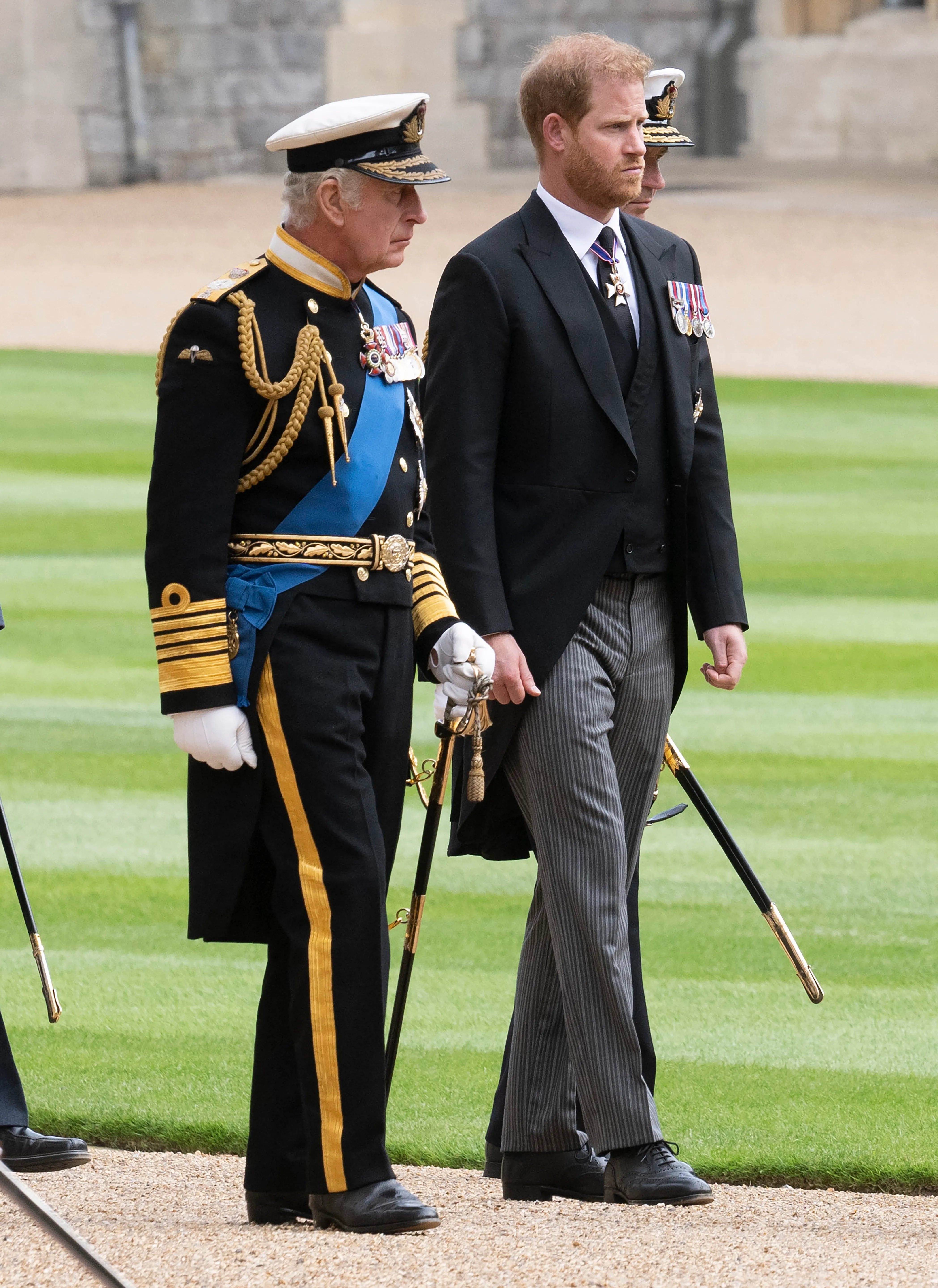 King Charles III and Prince Harry walk together during the committal service for Queen Elizabeth II.