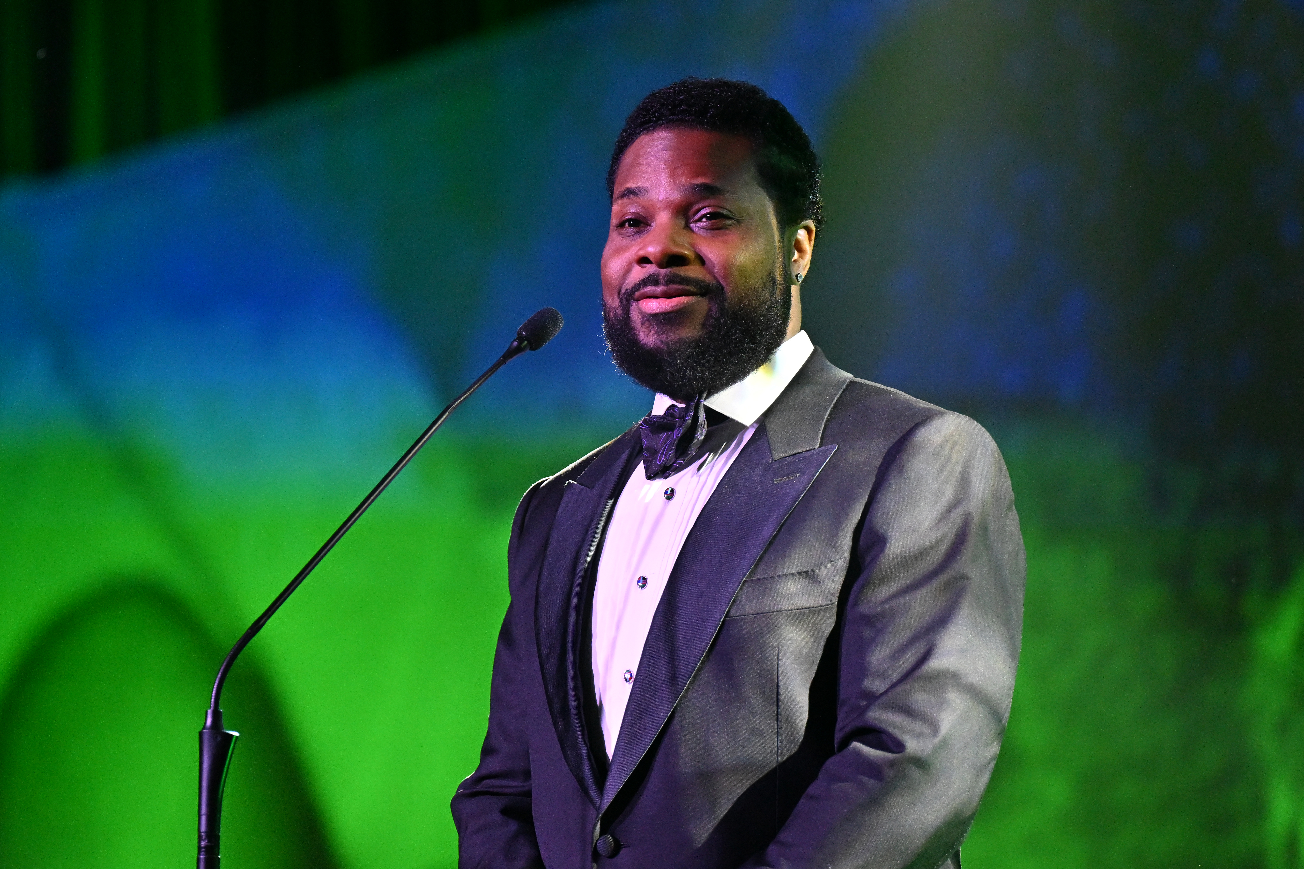 Host Malcolm-Jamal Warner speaks on stage at the 2023 Beloved Community Awards.