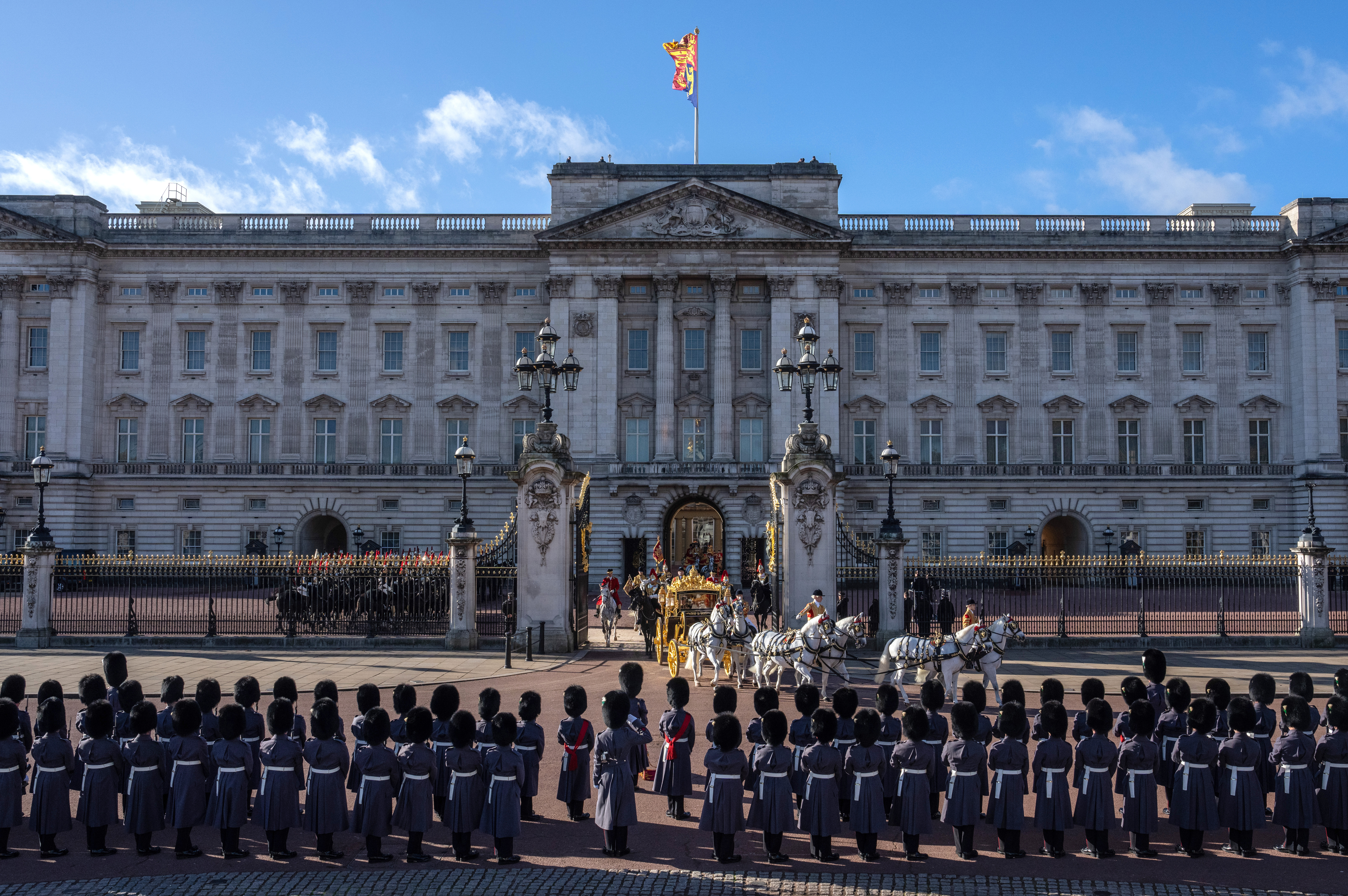 The King's Guard lined up outside Buckingham Palace as King Charles III and Queen Camilla departed in the Diamond Jubilee State Coach.