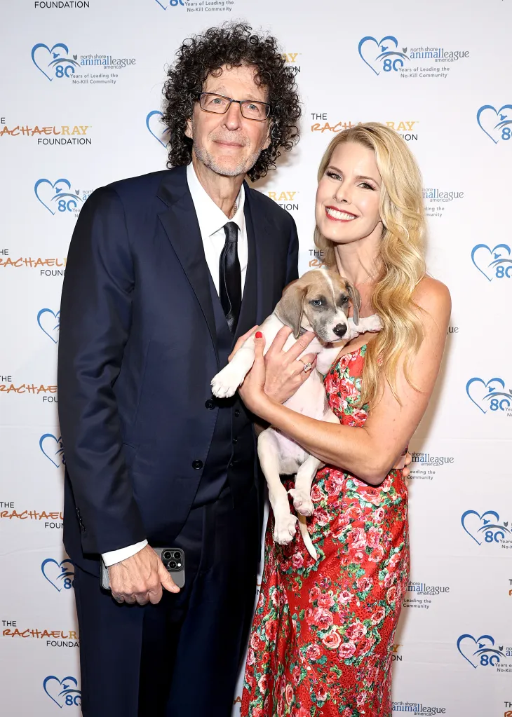 Howard Stern and Beth Stern, in a floral dress, hold a puppy at North Shore Animal League America's 2024 Celebration of Rescue.
