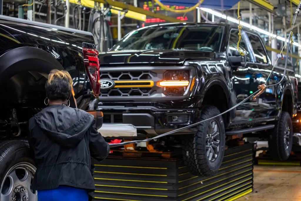 Workers assemble Ford vehicles at a plant in Michigan, where employees say malfunctioning self-checkout kiosks have led to wrongful theft accusations.