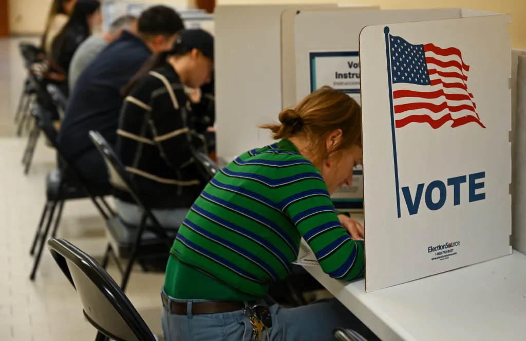 A woman casts her vote at a ballot booth inside the San Francisco Department of Elections on Election Day.