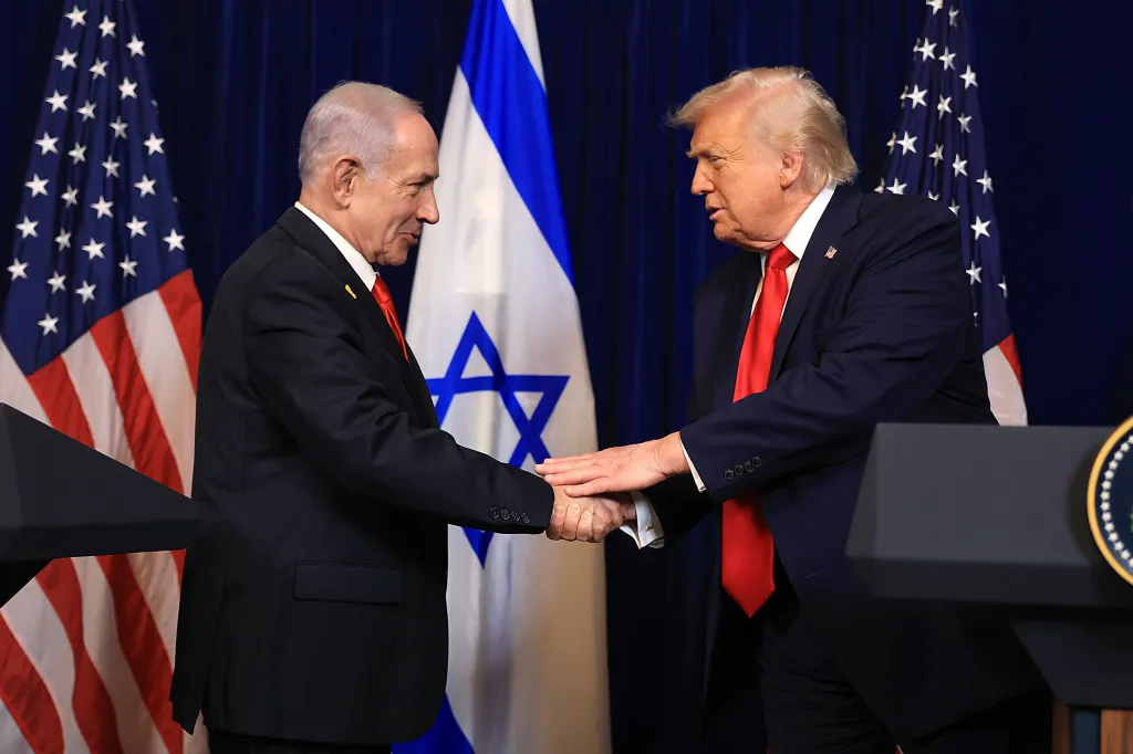 U.S. President Donald Trump and Israeli Prime Minister Benjamin Netanyahu shaking hands during a press conference.