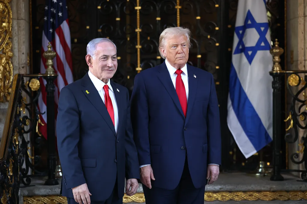 President Trump and Prime Minister Netanyahu stand before the flags of the US and Israel.
