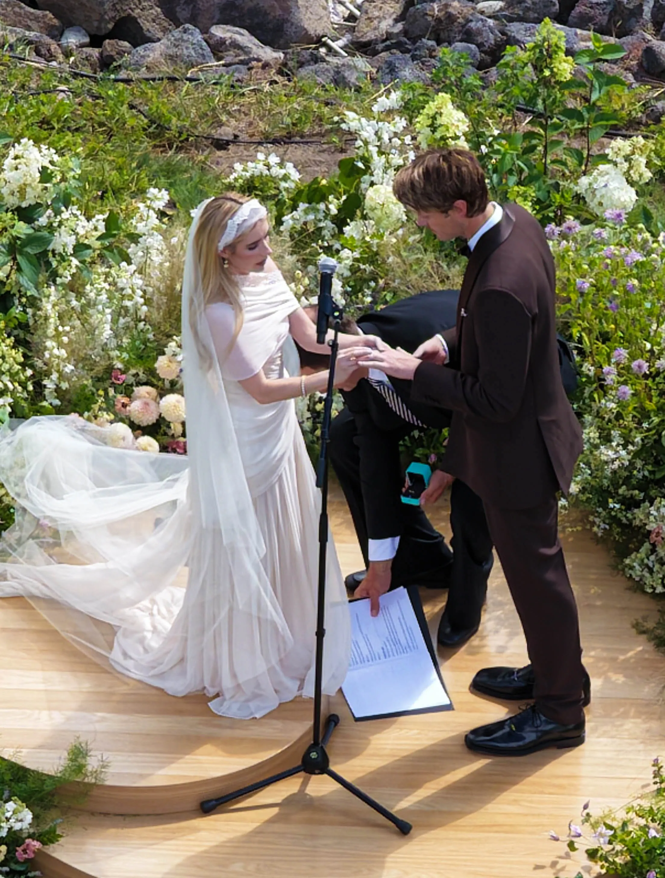 Emma Roberts and Cody John exchanging rings at their wedding ceremony.