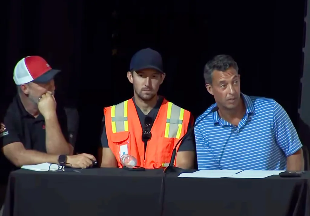 Three Lineage representatives seated at a table.