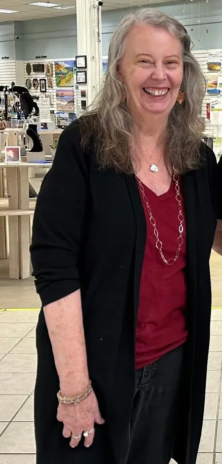 Rachell Summers smiling while wearing a red shirt and black cardigan.