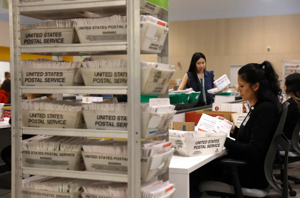 Election workers process ballots for the California state primary election.
