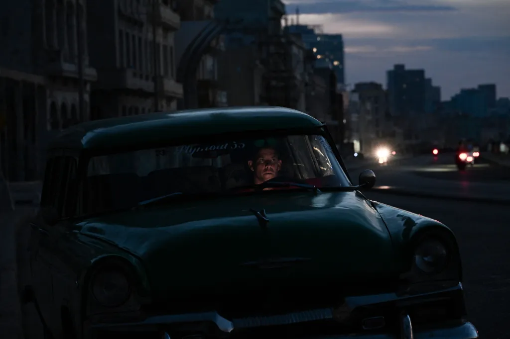 Man in a vintage car during a nationwide blackout in Havana.