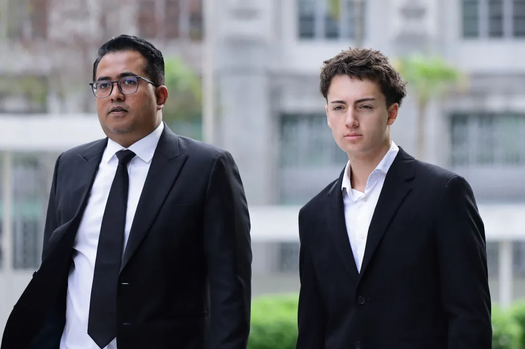 Didier Gaspard Owen Maximilien and his lawyer arrived at the State Courts in Singapore before he pleaded guilty on July 30, 2026.