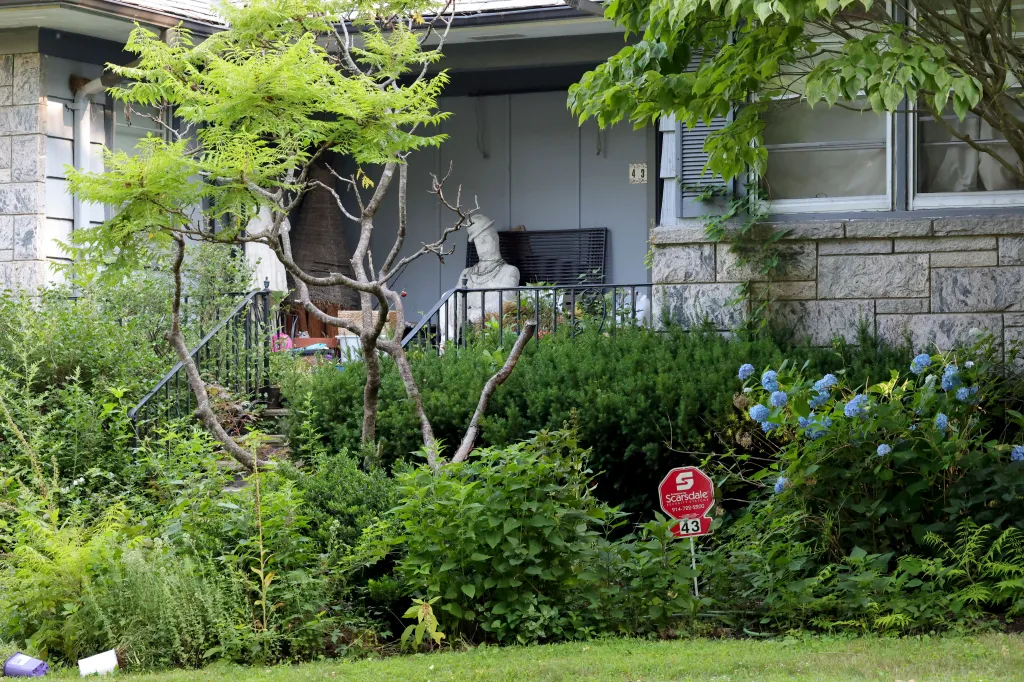 House at 43 Butler Road with a sculpture on the porch.
