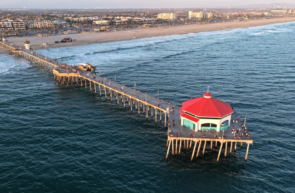 Aerial view of people on Huntington Beach Pier, California, over the Pacific Ocean.