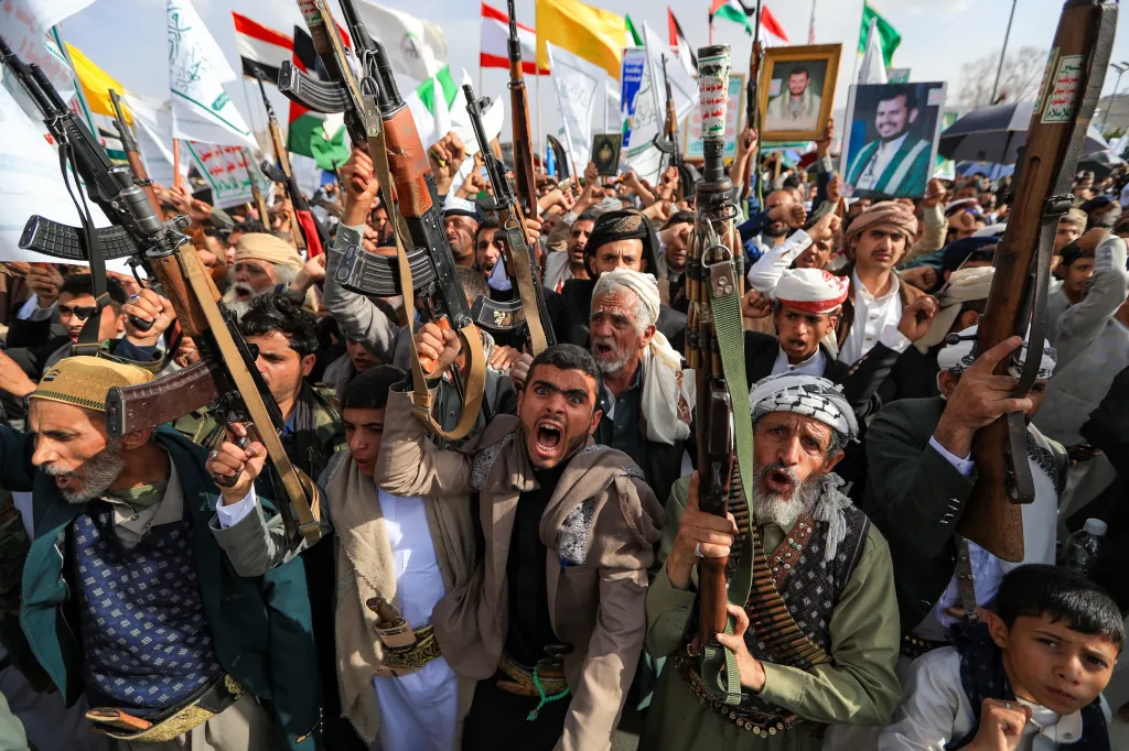 Armed Houthi supporters protest against US strikes on Iran in Sanaa.