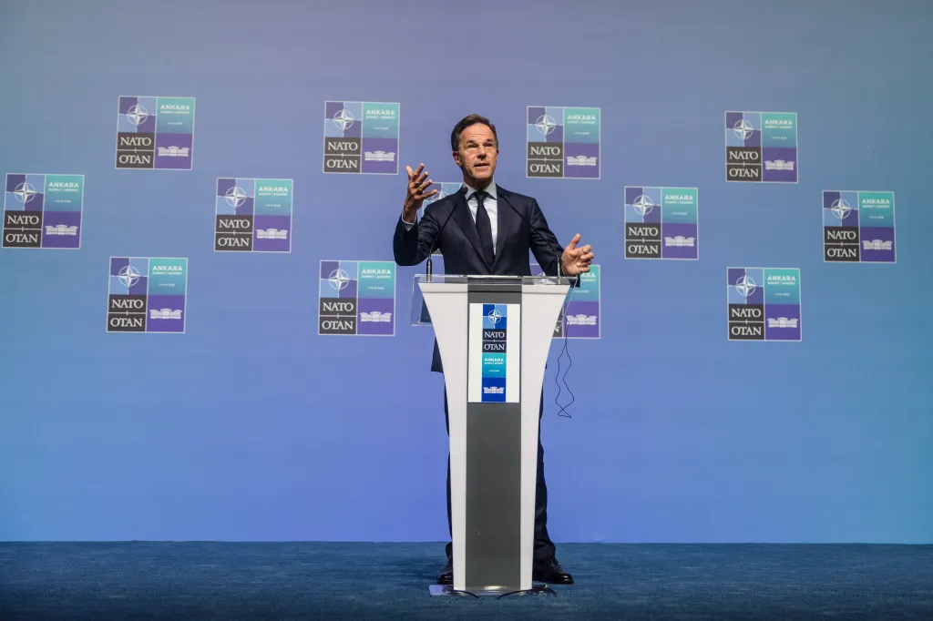 Mark Rutte, Secretary General of NATO, speaks at a press conference in front of a blue wall with NATO Summit 2026 logos.