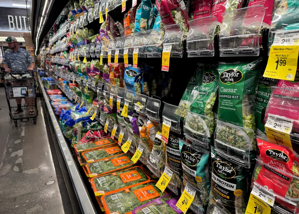 A supermarket aisle with lettuce produce