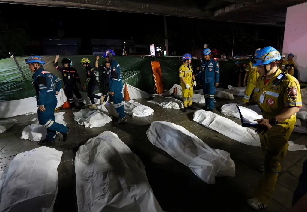 Rescue workers recover the bodies of fire victims outside the burned pub following a fire in Bangkok, Thailand, 13 July 13, 2026.