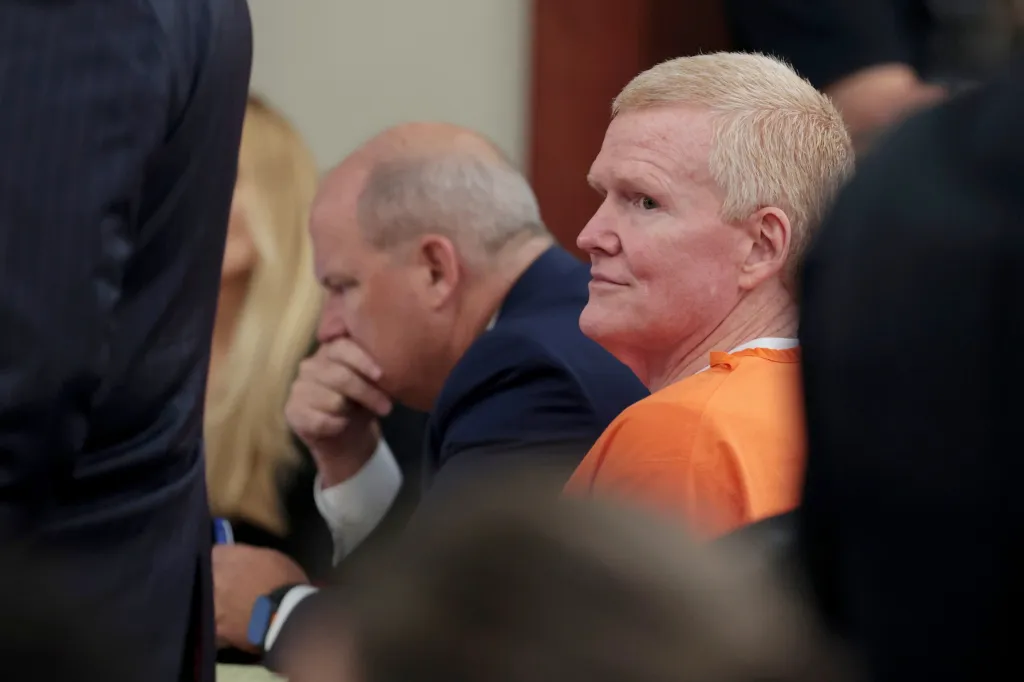 Alex Murdaugh, in an orange jumpsuit, attends a judicial hearing.