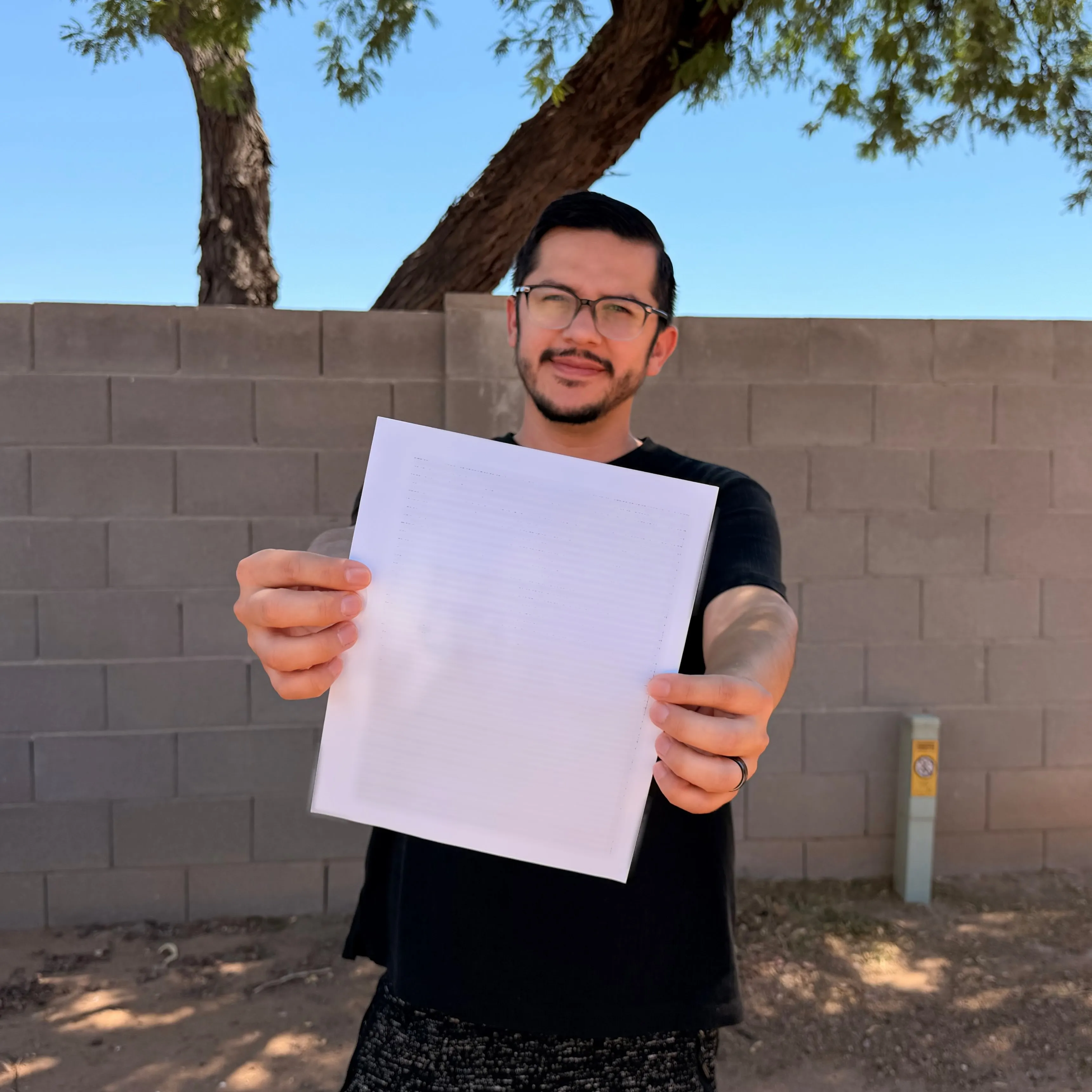 Armando Rubio holding a piece of paper that reads "2026" and indicates he can continue to remain in Arizona with Hannah.