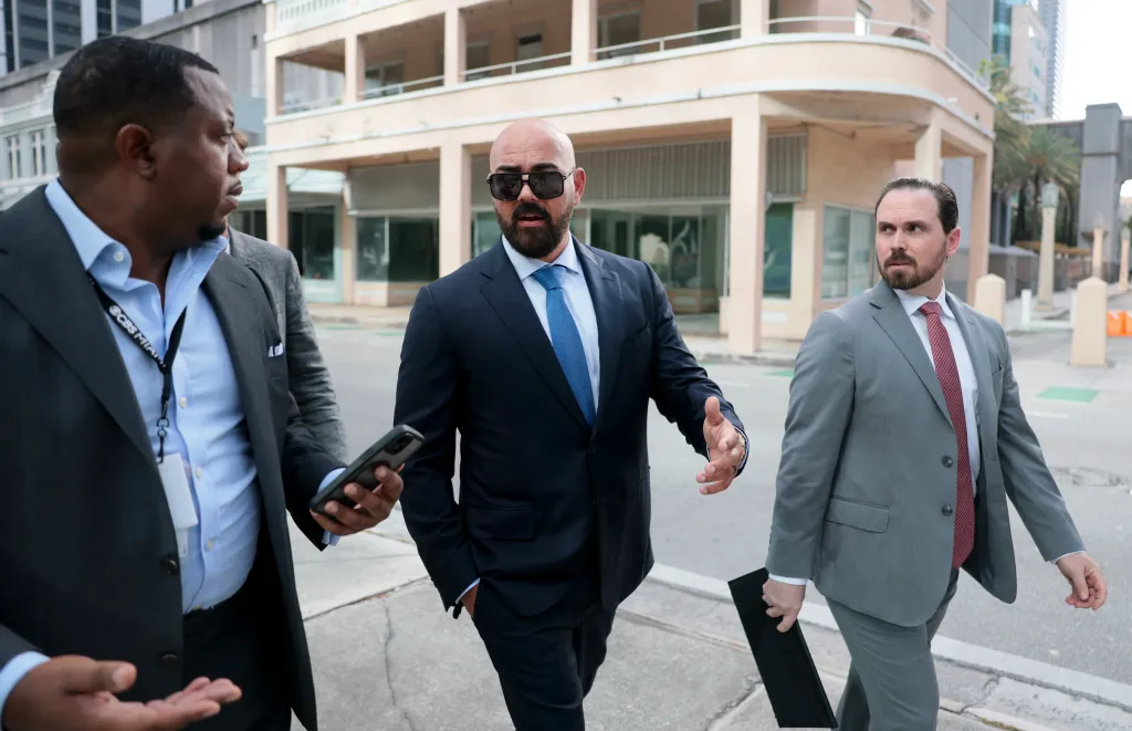 Lawyers Joseph McBride (left) and Thomas Maniotis (right) speaking to reporters outside the C. Clyde Atkins United States Courthouse.
