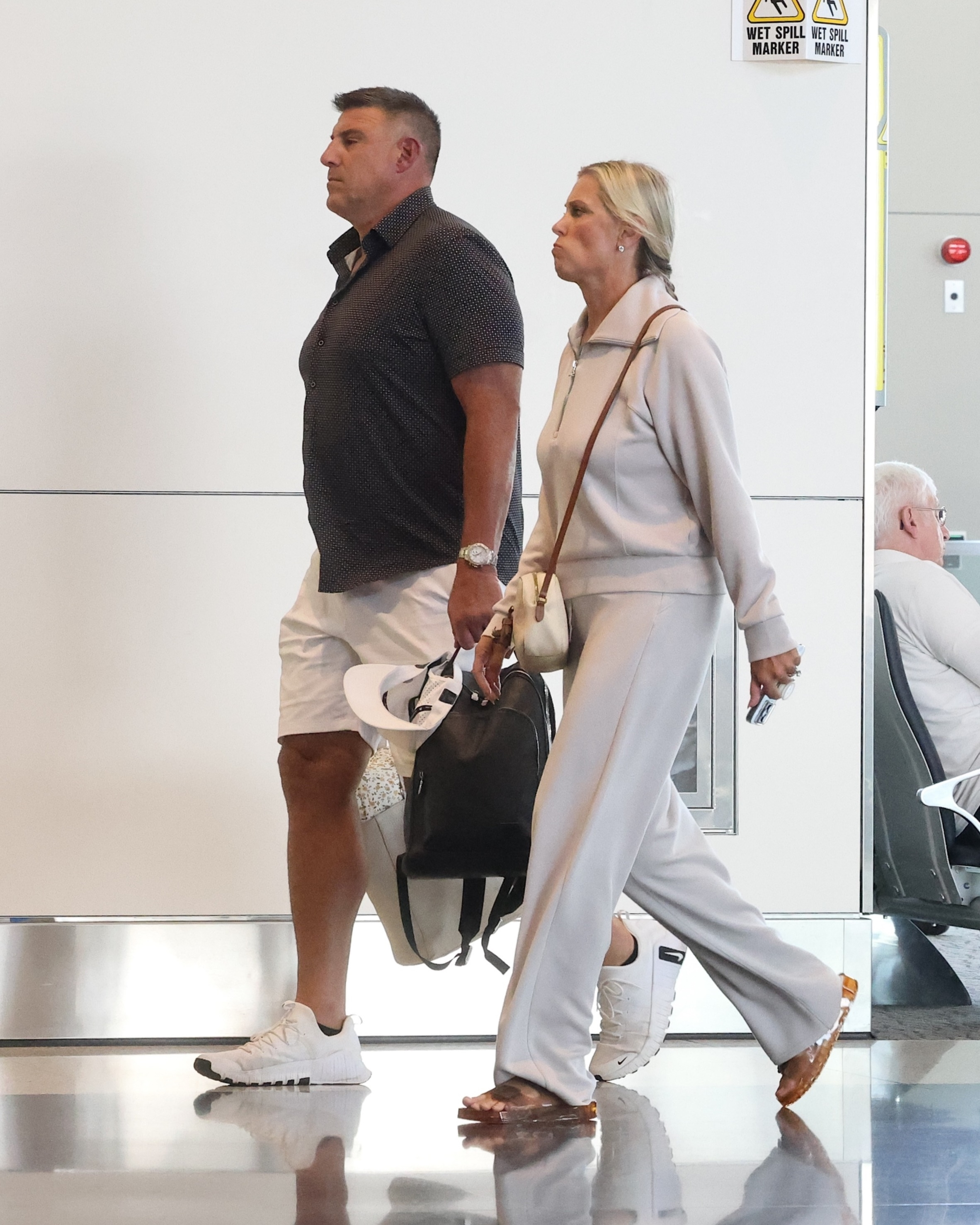 Mike and Jennifer Vrabel walking through an airport in Salt Lake City.