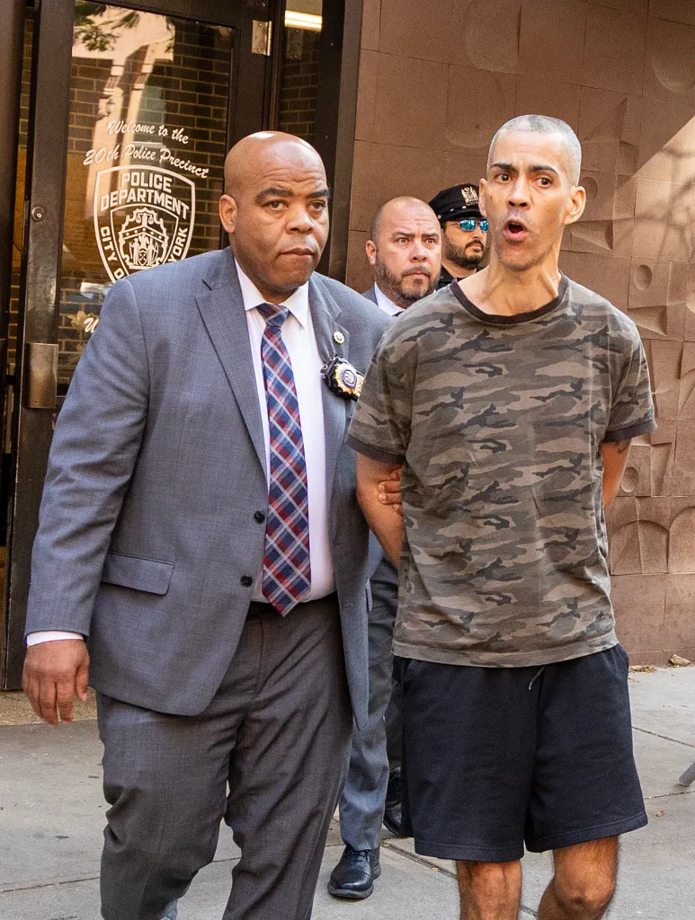NYPD detectives escort Raul Morales, 51, following his arrest in connection with two stabbing attacks.