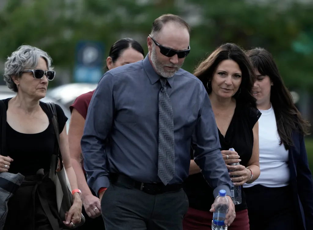 Tyler Robinson's parents Mathew and Amber leaving a July preliminary hearing in which prosecutors presented evidence against their son.