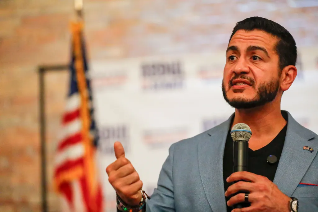 US Senate candidate Abdul El-Sayed speaking into a microphone at a rally in Grand Rapids, Michigan.