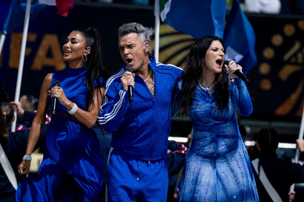 Robbie Williams, Nicole Scherzinger, and Laura Pausini perform on stage at the 2026 FIFA World Cup Final.